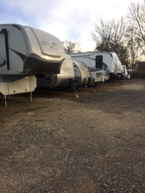 Fifth-wheel campers and travel trailers parked at the lot